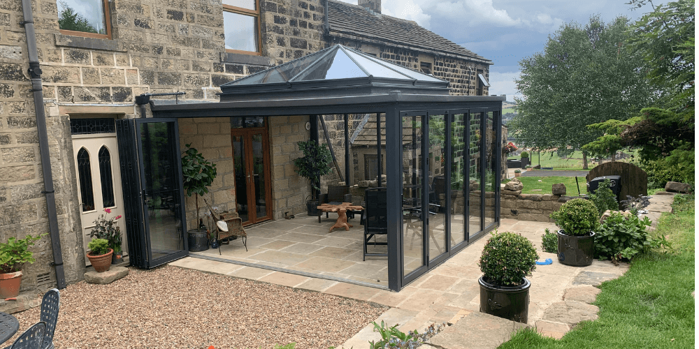 conservatory on farmhouse with aluminium bifold doors