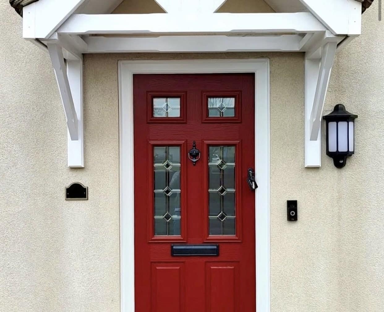 red composite front door with wooden porch