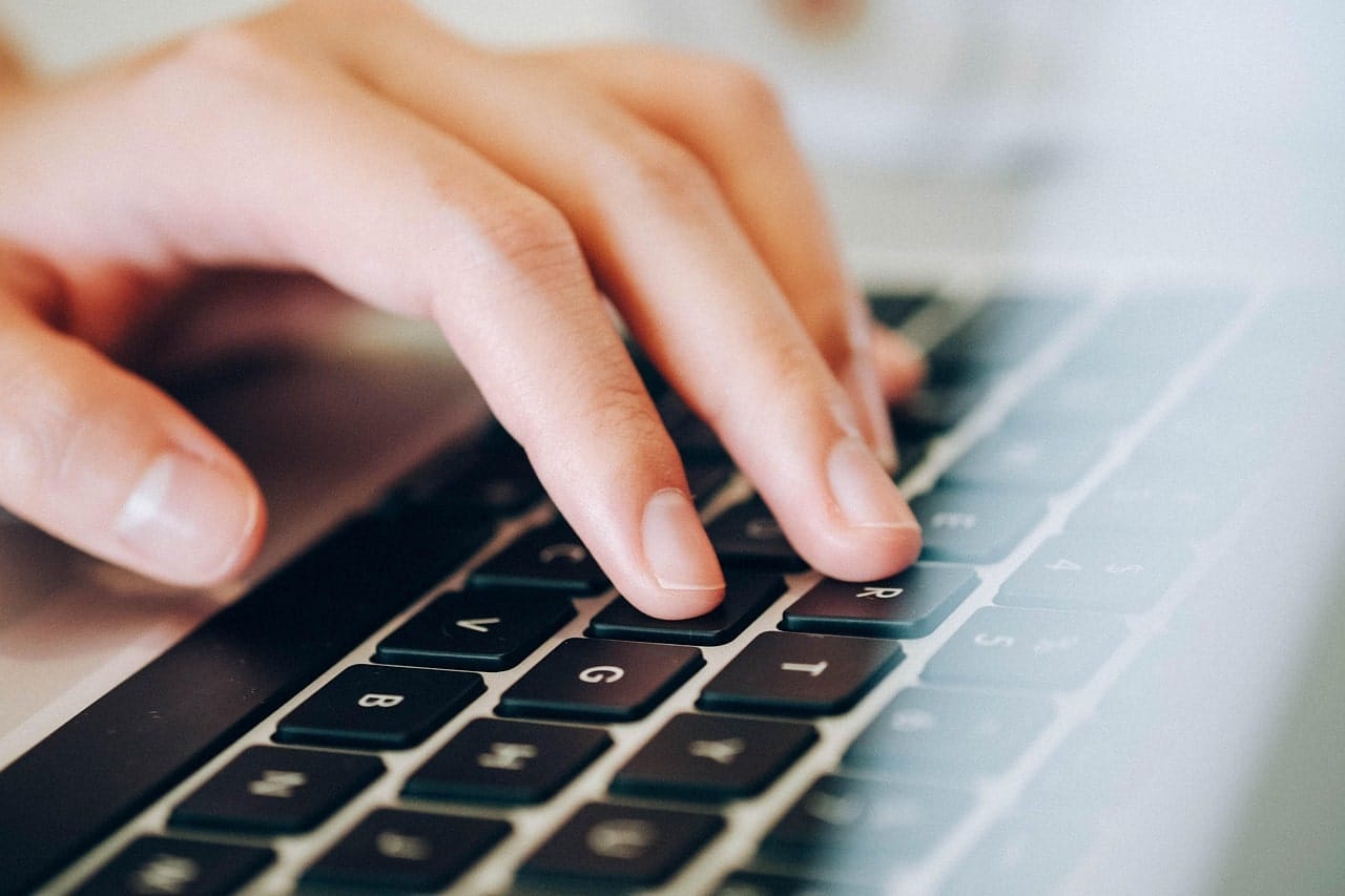 hand typing on keyboard