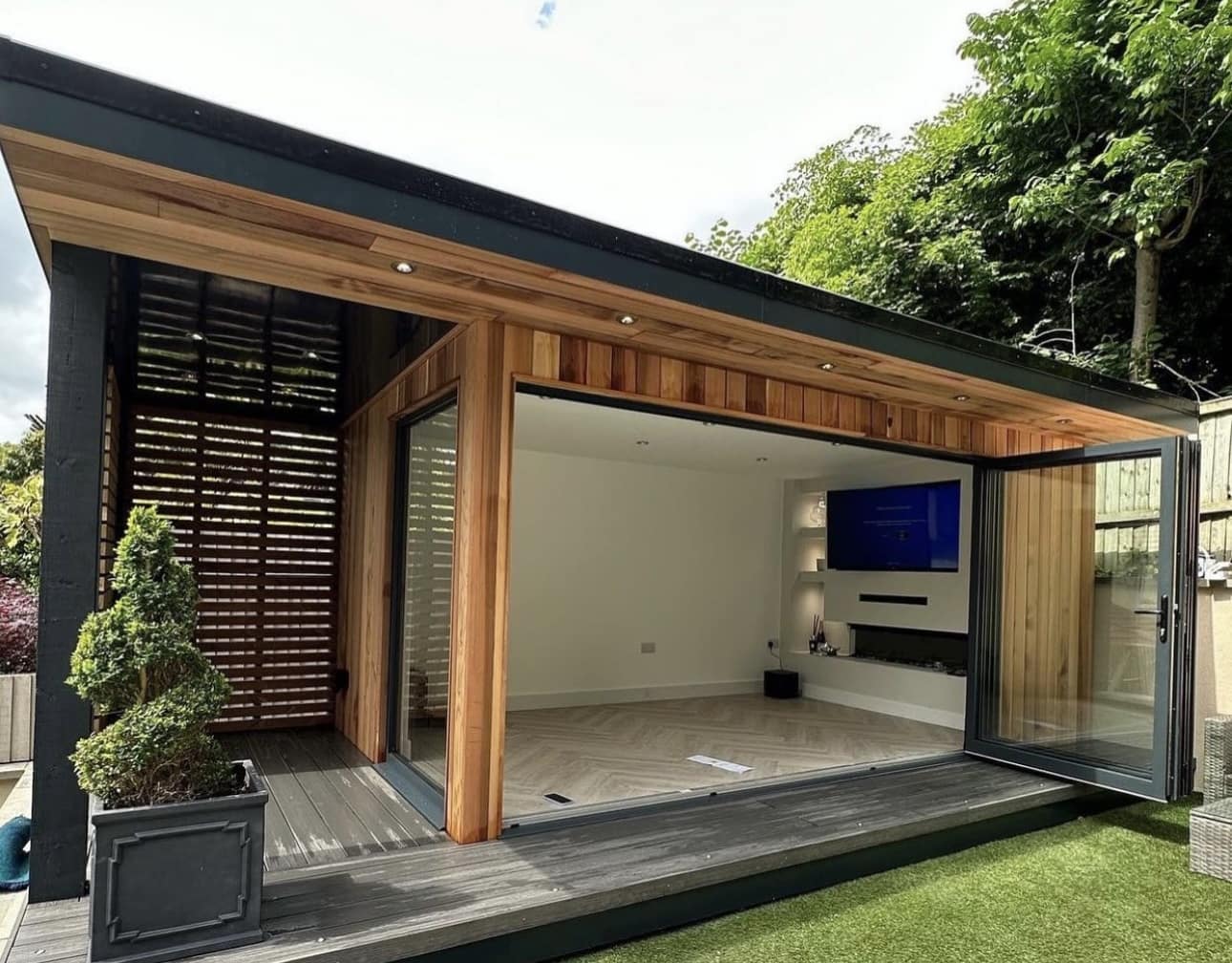 modern wooden garden room with cinema and aluminium bifold doors