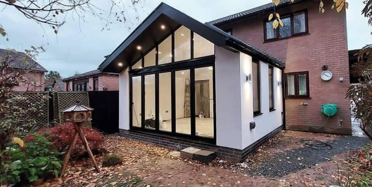 pitched extension on home with aluminium bifold doors and shaped frames