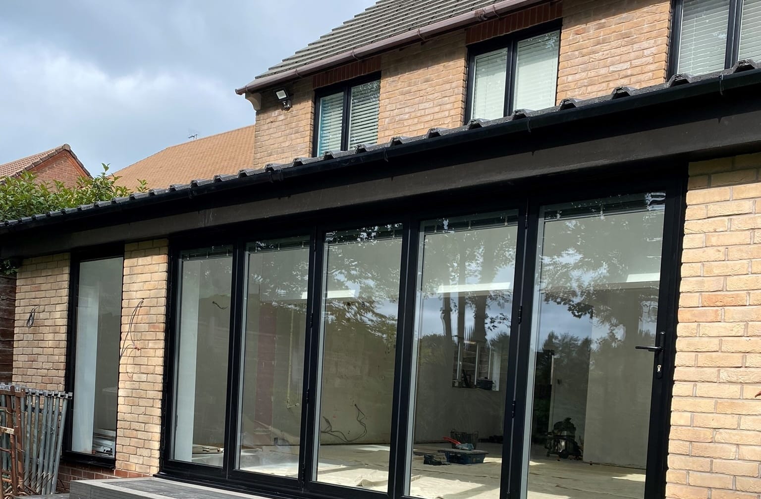 aluminium black bifold doors with fixed pane on kitchen extension
