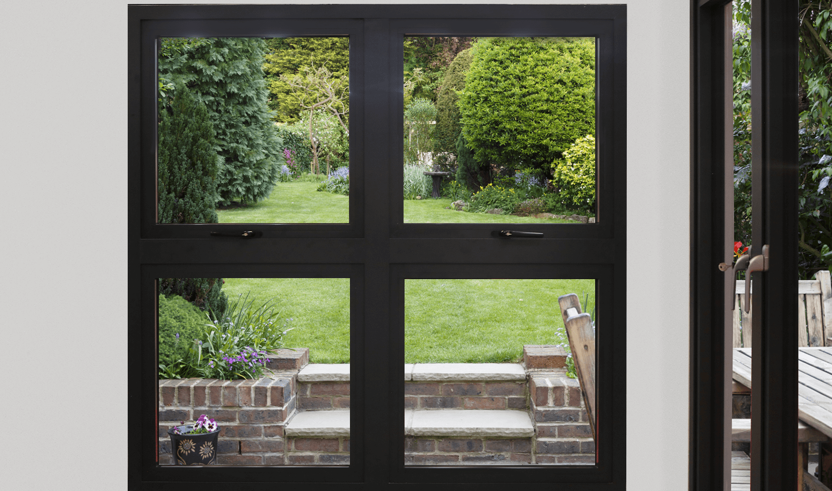 aluminium black window with openers looking into garden