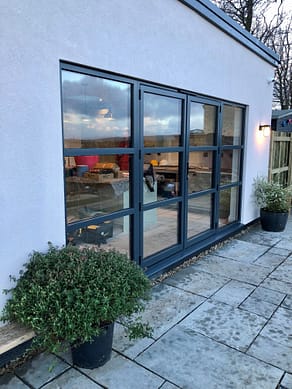 anthracite grey aluminium french doors with astragal bars and side panels on kitchen diner