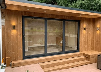 aluminium bifold doors on modern oak garden room