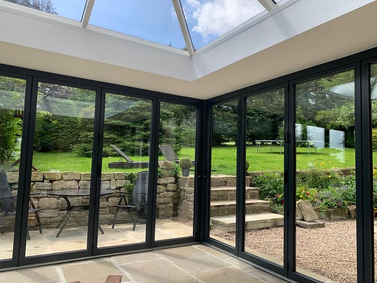 aluminium bifold doors in conservatory letting in light