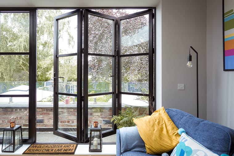 aluminium bifold door with traffic door sliding open