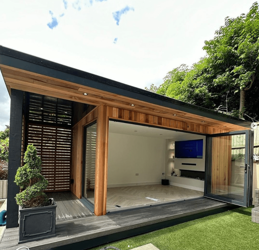 modern wooden garden room with cinema and aluminium bifold doors
